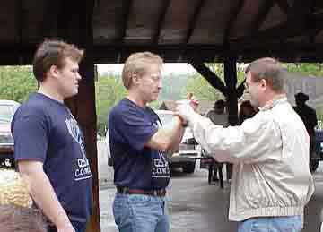 Picture of Art, Carel, and Chad discussing the drawing for the door prize