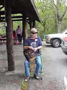 Picture of Jerry sitting on his walker smoking a pipe